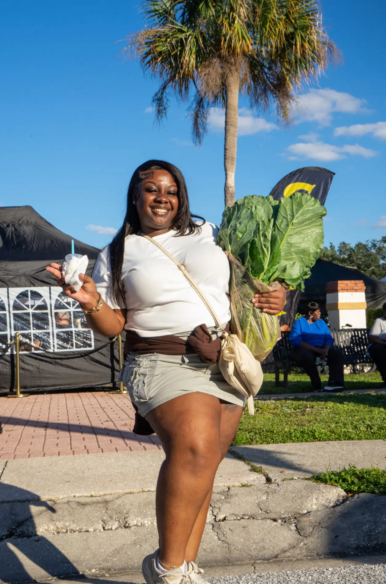 A resident holding fresh collard greens
